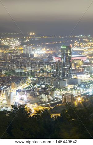 BILBAO, SPAIN - SEPTEMBER 1 2016: View of the illuminated city of Bilbao on a cloudy day. We can see the Salve bridge San Mames football stadium Iberdrola tower and the Guggenheim Museum.