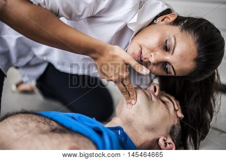girl assisting an unconscious man after fatal accident