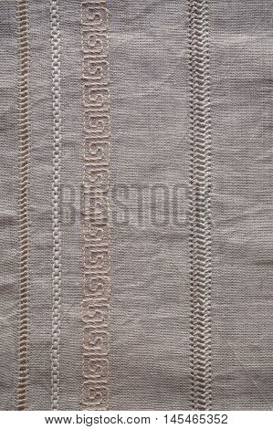 Background fragment of the hand embroidery on linen. Openwork pattern of longitudinal strips