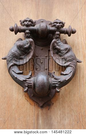 Old and ancient knocker in the city of Rome