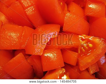Slices of tomatoes. Chopped tomatoes. Tomatoes cut into slices. Fresh tomatoes. Peeled tomatoes. Vegetable. Food. Product. Background.