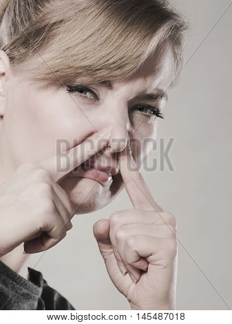 Girl Pinches Her Nose Because Of Stench Stink.