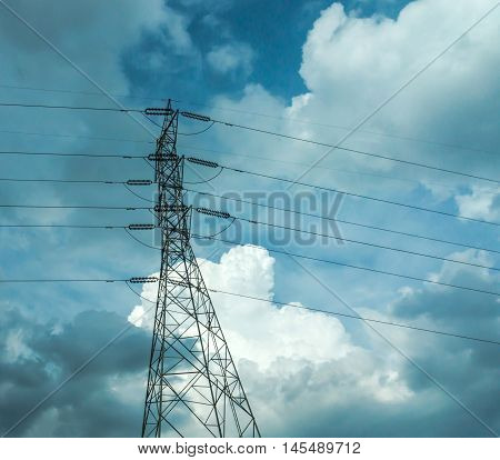 Electrical poles of high voltage in white cloud and blue sky / electric pole power lines and wires with blue sky / high voltage equipment on an electric pole / High-voltage sky background.