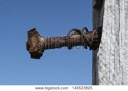 Old rusting bolt on a pylon on the Jetty Ruins at Myponga Beach Beach South Australia. Shallow focus used just on the bolt.