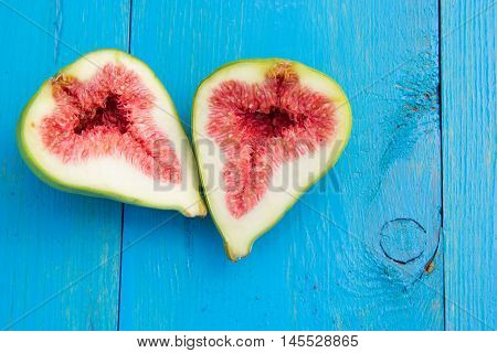 Slices of figs on a blue wooden table