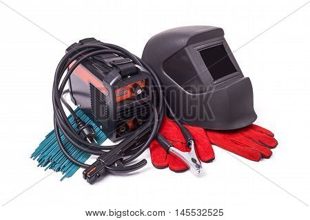 Inverter welding machine, isolated on a white background, welding mask, leather gloves, welding electrodes, high-voltage wires with clips, set of accessories for arc welding