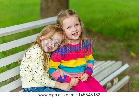 Two Beautiful Girlfriends Posing In The Garden