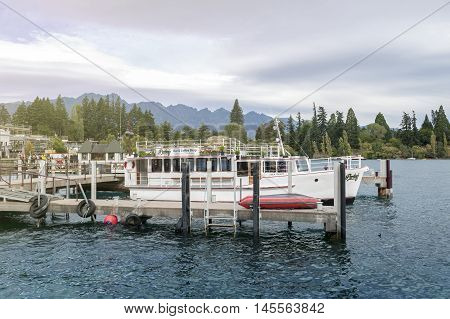 Queenstown New Zealand - March 2016: Boat piers at Queenstown lakefront by Lake Wakatipu New Zealand