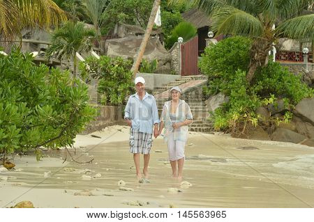 Happy elderly couple rest at tropical beac