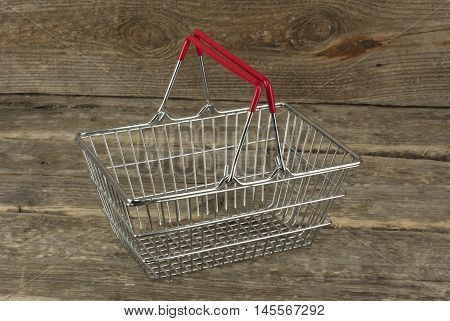 Consumer basket on the wooden background nobody candid ligt