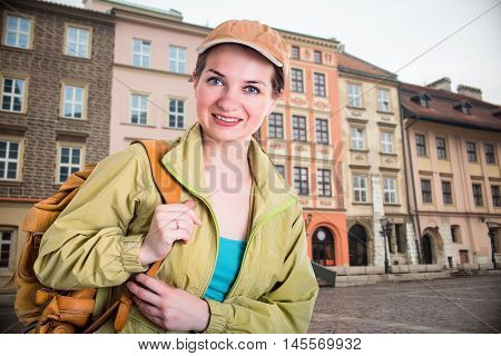 girl going on a journey. smiling tourist in the city with backpack