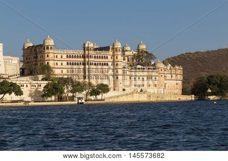 UDAIPUR INDIA - 20TH MARCH 2016: Part of the city palace in Udaipur during the day from the lake.