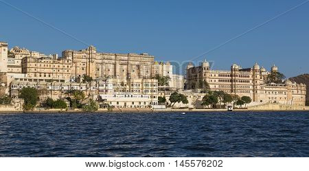 UDAIPUR INDIA - 20TH MARCH 2016: Part of the city palace in Udaipur during the day from the lake.