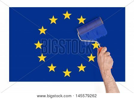 Close up view of a man's hand painting over a star on Europe Union flag. Brexit. British withdrawal. Euroscepticism.