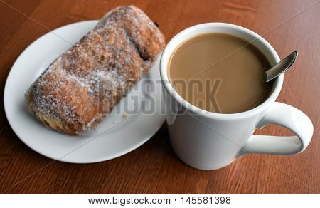 Coffee with cream and sugar doughnut filling with plum jam.