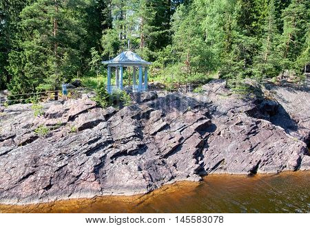 IMATRA, FINLAND - JULY 2, 2016: Man takes pictures near pavilion in front of the canyon of Imatrankoski (The Imatra Rapid) on The Vuoksi River.