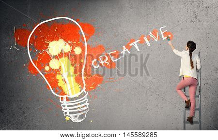 Young woman in casual drawing creativite idea concept on wall