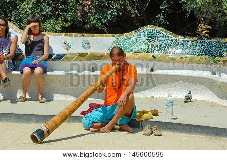 BARCELONA, SPAIN - MAY 06, 2005: Street musician play at Parc Guell in Barcelona