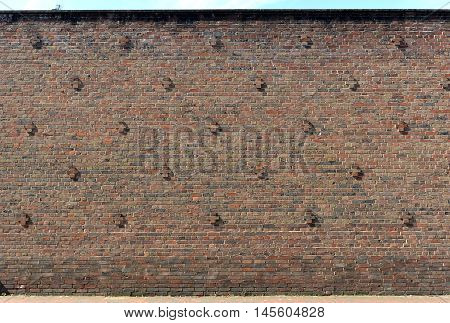Brick wall with cross motif and dustbin