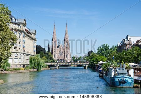 STRASBOURG, FRANCE. August 29th 2016. View of the River Ill, with St Paul's reformed church in the background.