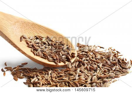 Cumin seeds and wooden spoon on white background