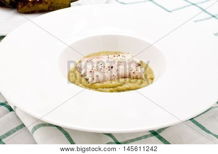 Fish cooked baked cod with friggitelli cooked in a pan with oil and garlic typical Italian vegetablesitaly