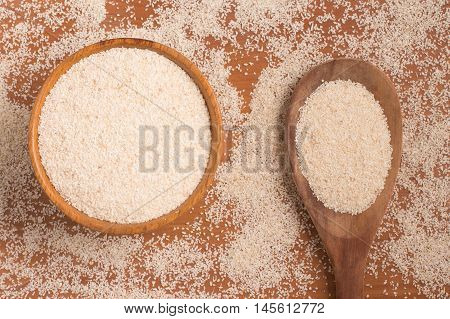 Farinha de Mandioca. Manioc. Cassava flour over a wooden table