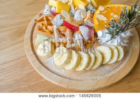 Pancake and fruit with ice cream on table