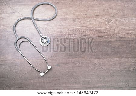 Stethscope isolated on wooden background with lighting