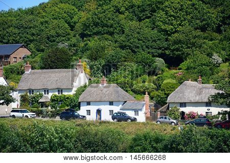 LULWORTH COVE, UNITED KINGDOM - JULY 19, 2016 - Thatched cottages along the village entrance Lulworth Cove Dorset England UK Western Europe, July 19, 2016.