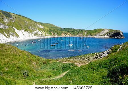 LULWORTH COVE, UNITED KINGDOM - JULY 19, 2016 - Elevated view of boats moored in the cove Lulworth Cove Dorset England UK Western Europe, July 19, 2016.