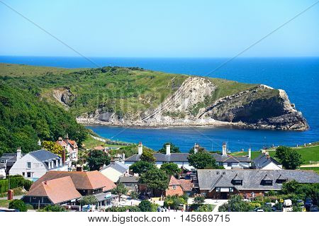 LULWORTH COVE, UNITED KINGDOM - JULY 19, 2016 - View looking down the hillside towards the cove and village Lulworth Cove Dorset England UK Western Europe, July 19, 2016.