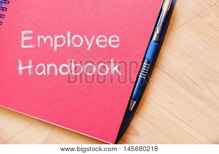 Employee handbook text concept write on notebook