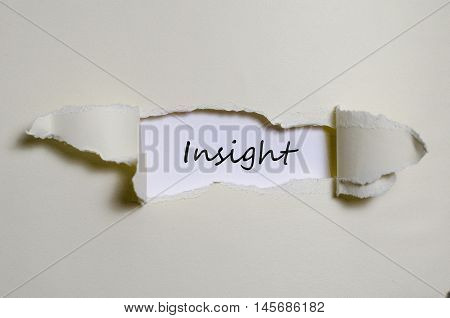The word insight appearing behind torn paper