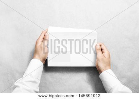 White blank envelope mock up holding in hand. Empty letter with transparent window design mockup. Message template presentation. Person opening clear mail.
