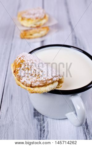 Homemade buns stuffed with cottage cheese on a wooden background. Selective focus.