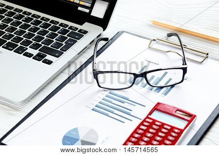 workplace economist at bright new office table with laptop