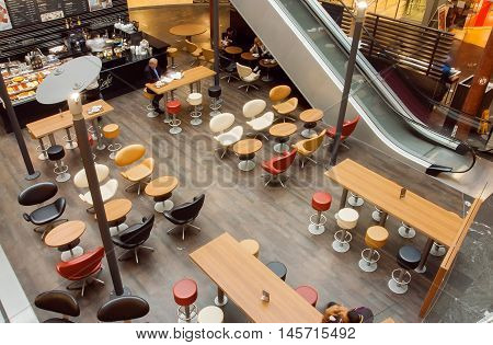 VIENNA, AUSTRIA - JUN 6, 2013: Urban city cafe inside the moderm shopping mall with customers on June 6, 2013. Vienna city has population near 1.8 million
