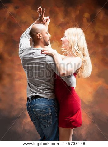 Young and sexy couple dances Caribbean Salsa