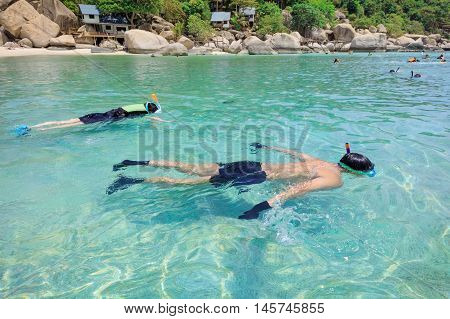 Snorkeling on an island beach with cristal clear water