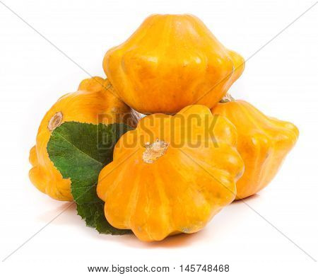 four yellow pattypan squash with leaf isolated on white background.