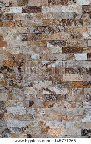 Background of a stone wall cladding texture brown stone bricks