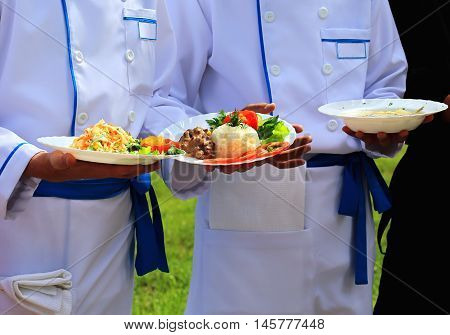 Chefs offer culinary specialties on plates for competition
