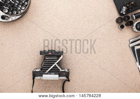 Many vintage cameras on wooden table. Photographer Desk. Photographer workplace. Tradional Photography. Black and White Photography. Negatives. Roll of films.