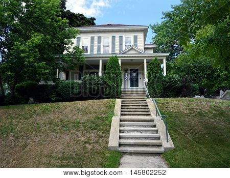 PETOSKEY, MICHIGAN / UNITED STATES - AUGUST 5, 2016: A Victorian home with a wraparound porch on Mitchell Street near downtown Petoskey.