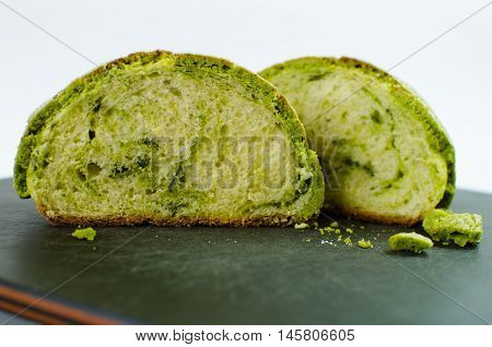 Slices of Japanese bread melon pan on black cutting board
