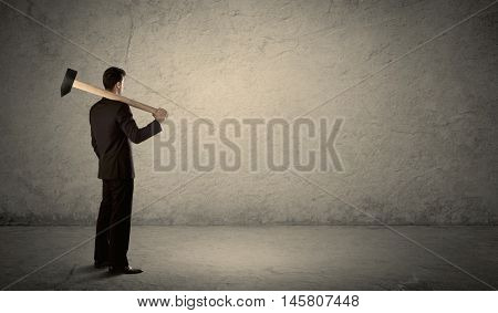 A businessman in modern stylish elegant suit standing on a small ladder and drawing pie and block charts on grey wall background with exponential progressing curves, lines, circles, blocks, numbers