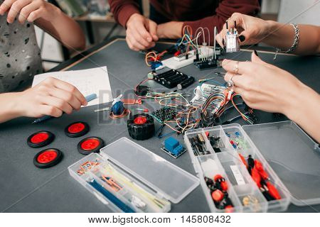 Construction of electronic car with microcontroller. Collective creation of diy electronics, modern technologies, innovation and science concept