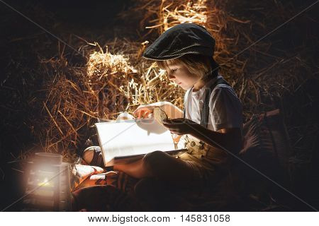 Sweet Child, Boy, Reading A Book On The Attic On A House, Sitting On A Hay Of Straw