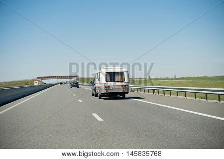 MARSEILLE FRANCE - MAY 05 2016: Eriba RV van and trailer driving fast to vacance destination on highwayon a summer day